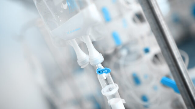Drip bag in the hospital ward on the background of equipment